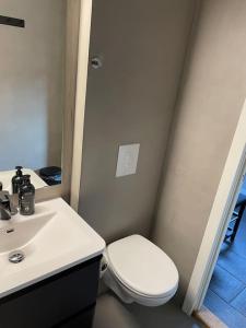 a bathroom with a white toilet and a sink at Practical apartment near city center in Stavanger