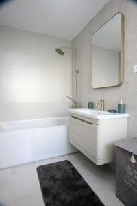 a white bathroom with a sink and a mirror at Venima City Center Apartment in Tivat +52 photos