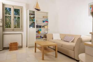 a living room with a couch and a coffee table at Kiter's paradise beach house in Pounda
