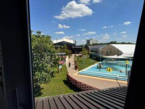 a view from a window of a swimming pool at FÜRDŐ PANZIÓ in Karcag