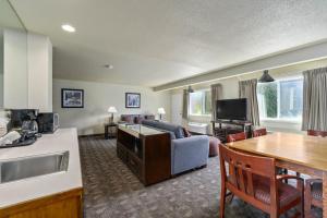 a kitchen and living room with a couch and a table at Cocusa Motel in Burlington