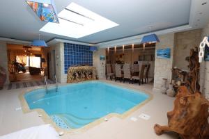 a large swimming pool in a living room at Villa Sunset Siviri in Siviri