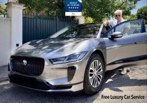 a man is getting out of a jaguar car at LES ANGES DELUXE AVIGNON - Exclusive Romantic Home - Private Luxury Tours in Avignon
