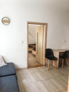 a living room with a door leading to a bedroom at M&C Apartmans in Olomouc +12 photos