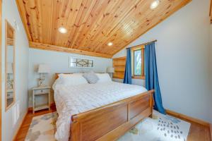 a bedroom with a bed and a wooden ceiling at Peaceful Warrenville Home 1 Mi to Herrick Lake! in Warrenville