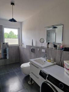 a bathroom with a toilet and a sink and a mirror at Haus Emilia in Sierosław