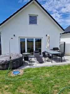 a house with a patio with a table and chairs at Haus Emilia in Sierosław