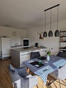 a kitchen with a table and chairs in a kitchen at Haus Emilia in Sierosław +16 photos