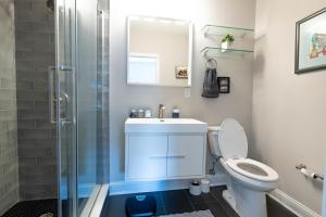 een badkamer met toilet, wastafel en douche bij Stylish 3BR w Pool Table & Garage in Philadelphia +35 foto's