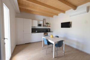 a kitchen and dining room with a table and chairs at La casa nel verde in Recanati +30 photos