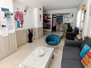 a living room with a couch and a table at Hostal Horizonte in San Antonio