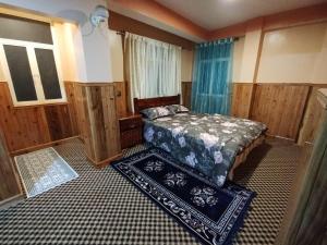 a bedroom with a bed and a window at Lepcha Homestay Darjeeling in Darjeeling