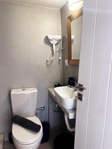 a bathroom with a white toilet and a sink at Kimolos Seafront in Kimolos