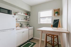a kitchen with a table with a chalkboard on it at Private Studio Walk to Beach -- Apartment 2 in Pompano Beach