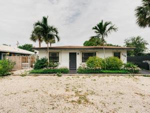 a house with palm trees in front of it at Private Studio Walk to Beach -- Apartment 2 in Pompano Beach +2 photos