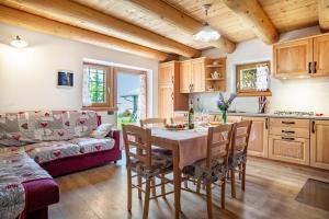 a kitchen and living room with a table and chairs at Baita Naibiz in Palù del Fersina