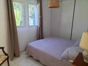a bedroom with a bed and a window at Appartement au Calme in Saint-Cézaire-sur-Siagne