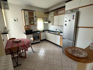a kitchen with a table and a refrigerator at rocco salento home in Lecce