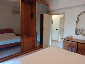 a bedroom with a mirror and a bed and a dresser at rocco salento home in Lecce