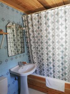 a bathroom with a sink and a shower curtain at Hostal Ochoa in San Adrián