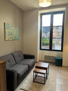 a living room with a couch and a coffee table at Quai de la Loire in Blois
