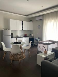 a kitchen and living room with a table and chairs at Lydia Apartment in Vonitsa