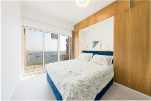 a bedroom with a bed and a large window at What a view - very close to DMCC metro station in Dubai