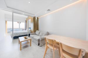 a living room with a couch and a table at What a view - very close to DMCC metro station in Dubai