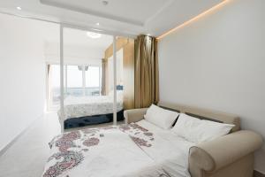 a bedroom with a bed and a large window at What a view - very close to DMCC metro station in Dubai