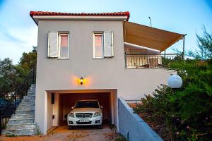a car is parked inside of a house at Romanos Beach Villas in Romanu