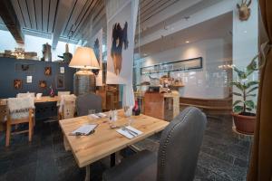 una sala da pranzo con tavolo e sedie in legno di Chesa Stuva Colani a Madulain