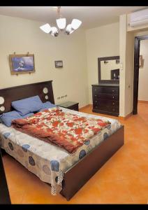 a bedroom with a bed with a dresser and a mirror at porto elsokhna in Ain Sokhna +48 photos
