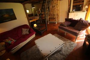a living room with a couch and a coffee table at Le chant du coucou in Bois Gars