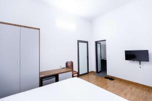 a bedroom with a bed and a tv on a wall at Tam coc Newway Homestay in Ninh Binh