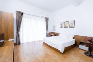 a bedroom with a bed and a television in it at Tam coc Newway Homestay in Ninh Binh