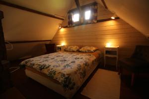 a bedroom with a bed with two pillows on it at Le chant du coucou in Bois Gars