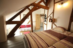 a bedroom with a bed in a attic at Le chant du coucou in Bois Gars +22 photos