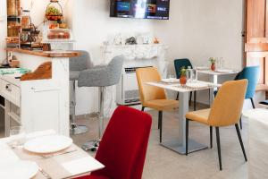 a dining room with tables and chairs and a fireplace at Executive B&B in Scafa