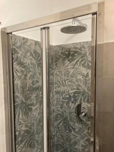 a shower with a glass door in a bathroom at Appartamenti Aspromonte in Milan