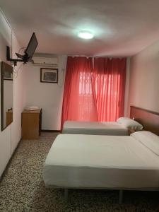 Postel nebo postele na pokoji v ubytování Hotel Iris