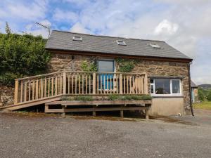 a house with a wooden deck in front of it at The Grain Store in Abersoch
