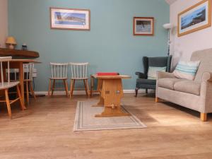 a living room with a couch and a table and chairs at The Grain Store in Abersoch