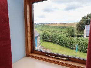 a window with a view of a field at The Grain Store in Abersoch