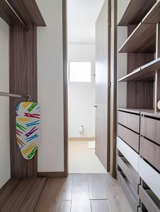 a kitchen with white cabinets and a surfboard on the door at 2 Dormitorios Vista Mar. Piscina y Spa in Gaira