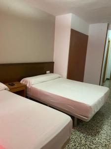 Postel nebo postele na pokoji v ubytování Hotel Iris