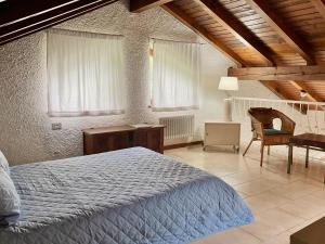a bedroom with a bed and a desk and a chair at Casa Azalea in Luino
