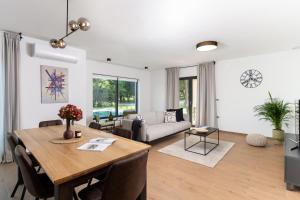 a dining room and living room with a table and chairs at Villa Photinia in Labin