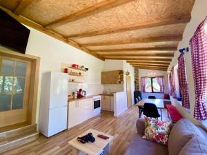 a living room with a couch and a kitchen at Visoravan 1200 in Kupres