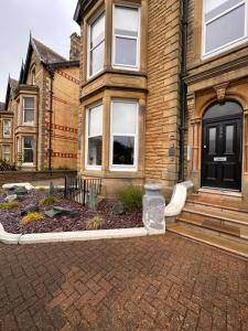 a house with a garden in front of it at No1,luxury 1 bed apartment in Saint Annes on the Sea
