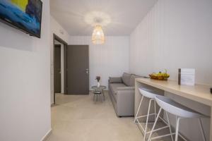 a living room with a couch and a table at Aplomata Naxos Apartments in Naxos Chora